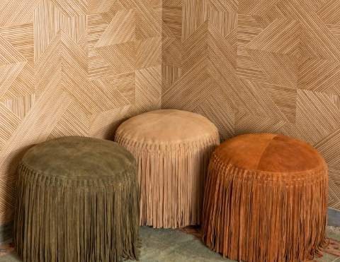 Three fringe poufs in a living room
